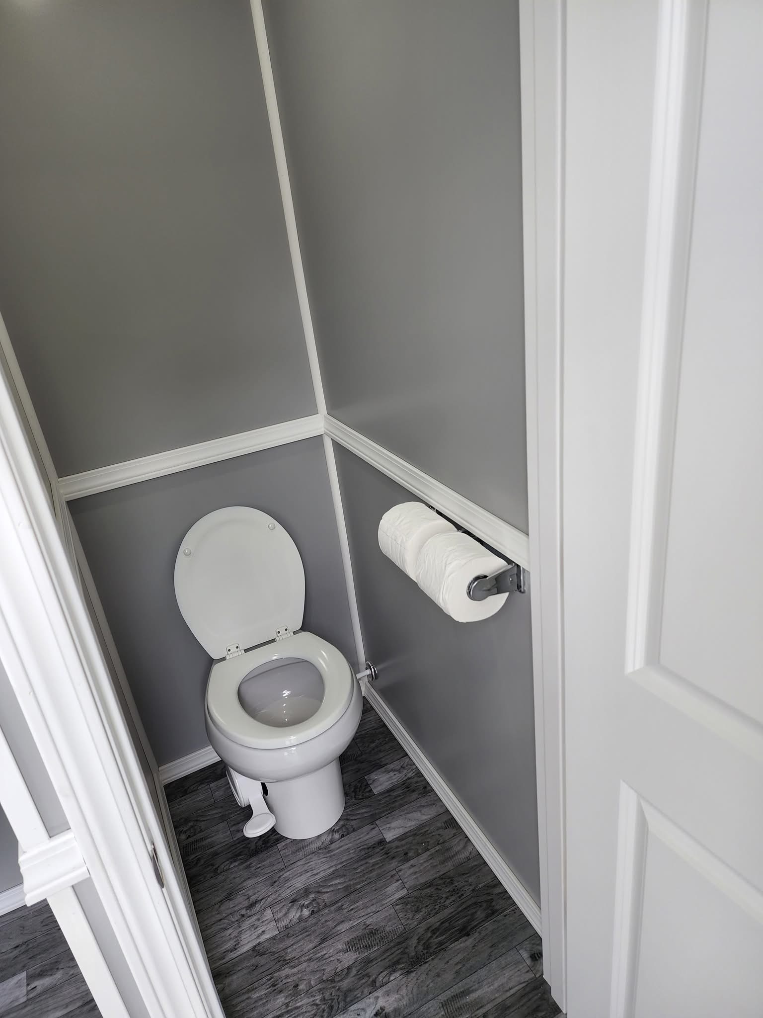 Portable restroom placed near active farm work area before weekend crew arrives