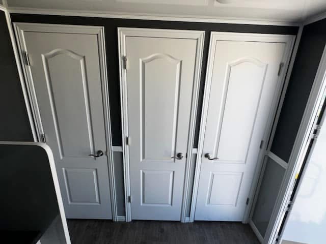 Portable restroom delivered beside active barn venue before guests arrive for event