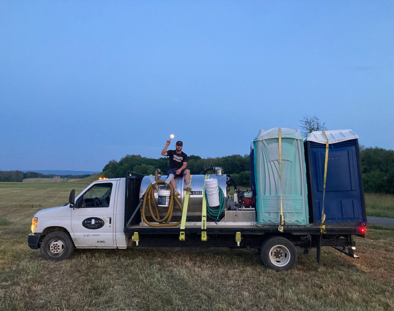 Site manager assessing portable restroom placement with event layout and access plan